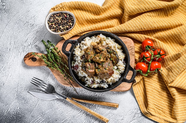 Madras beef with basmati rice in a pan with a tablecloth