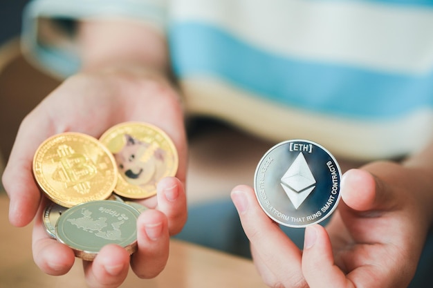 Photo maesot, thailand- june 13, 2021:a woman's hand holding a ethereum coin, new concept cryptocurrency virtual money is the future of digital currency online financial payments.