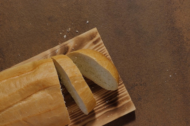 mage of a loaf of bread cut into slices on a kitchen board