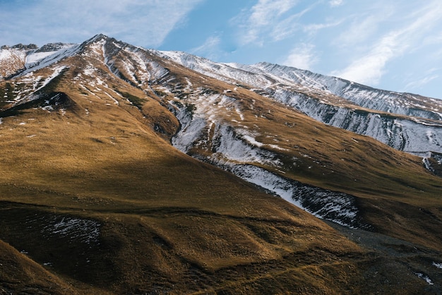 Magic enchanting nature and autumn landscape high mountains and hills covered with white snow