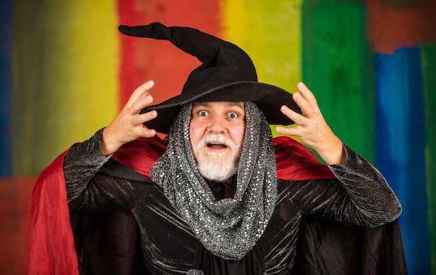 Photo magic of magician experienced and wise wizard costume hat halloween party halloween wide banner halloween decoration and scary concept 31 october gothic man in halloween costume