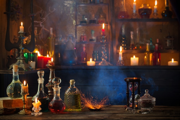 Magic potions in bottles on wooden background