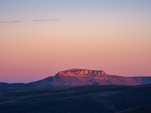 Magical magenta dawn over the Bermamyt plateau Atmospheric dawn landscape with beautiful Bermamyt plateau is in the distance