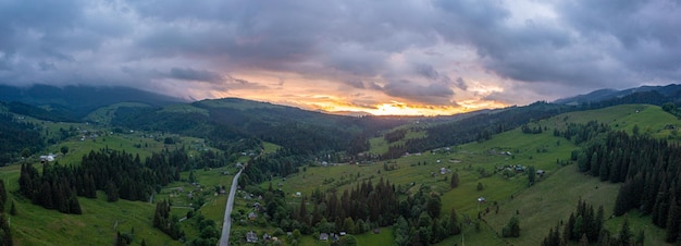 Magical sunset over the green hills and mountains