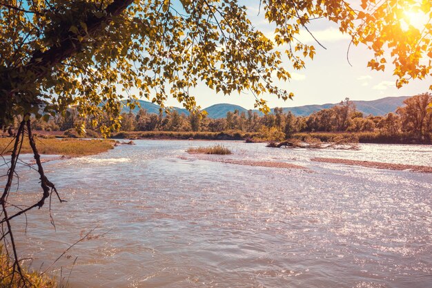 Magical sunset over the river in a mountain valley River in the evening Nature landscape