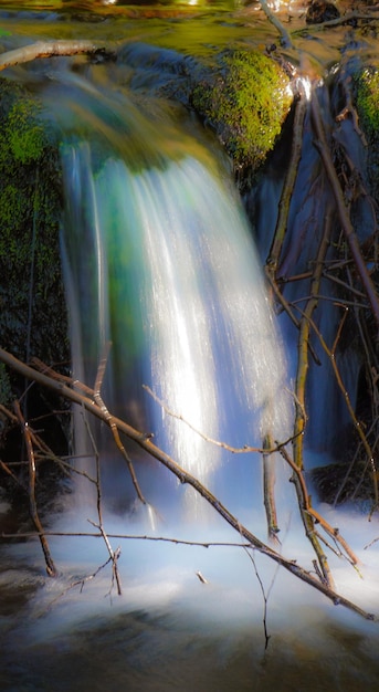 Magical waterfall falling into a river in Galicia Slow motion