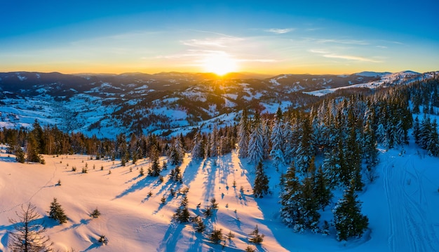 Magical winter panorama of beautiful snowy slopes at a ski resort in Europe on a sunny, windless frosty day. The concept of active recreation in winter