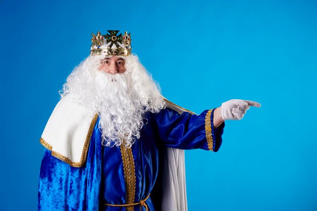 The magician king pointing to a billboard on a blue background