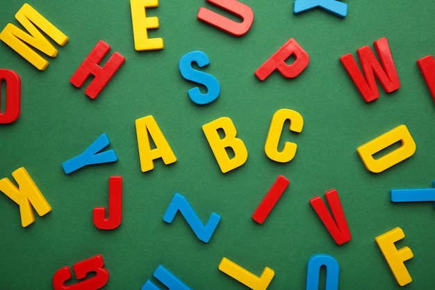 Magnetic plastic alphabet letters on green background