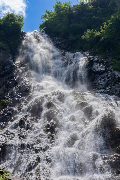 A magnificent large waterfall with an unusual relief of stones