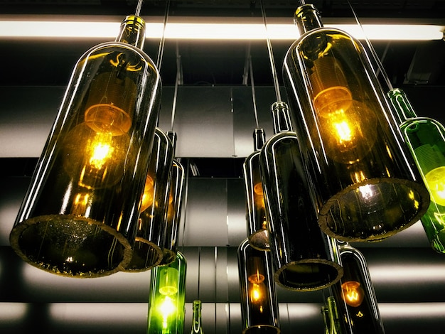 Magnificent retro light lamps decor made of the wine bottles. Toned