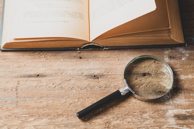 Magnifier and book. concept study material