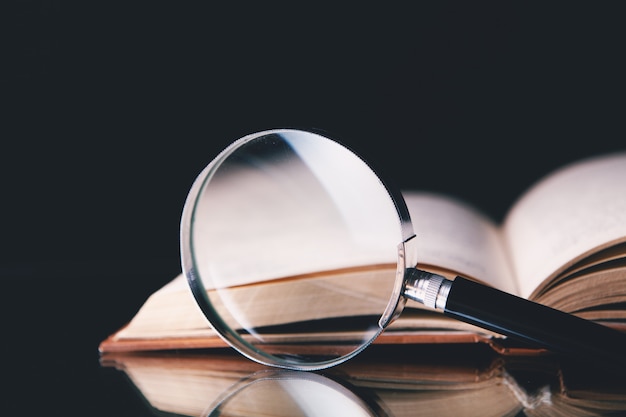 Magnifier and book on the table