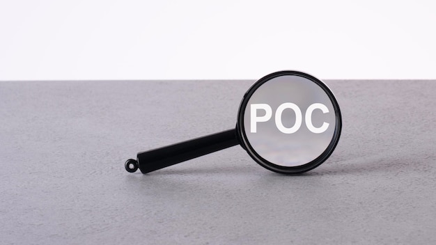 Magnifier focuses on the word POC finding detecting or focusing on a problem and analyzing for business