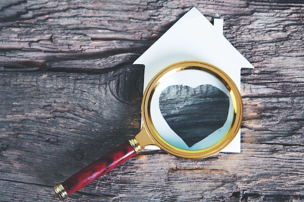 Magnifier and house on the table