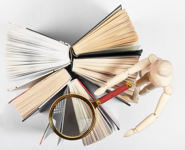 Magnifier wood person reading and studying books concept of knowledge research