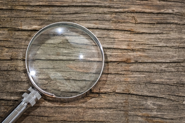 Magnifier on the wooden table with copy space