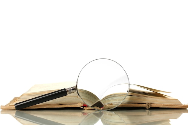 Magnifying glass and book isolated on white