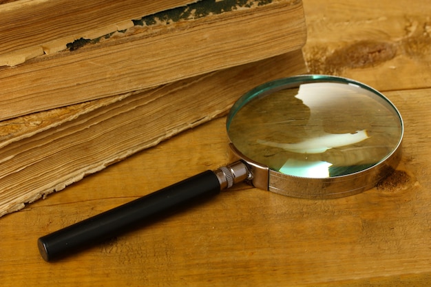 magnifying glass and books on table