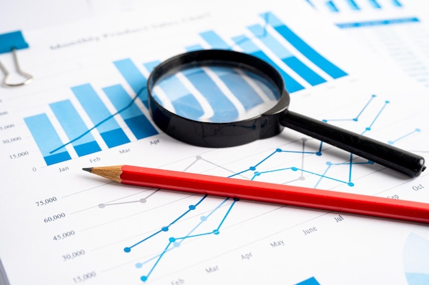 Magnifying glass on charts graphs paper. Financial development, Banking Account, Statistics, Investment Analytic research data economy, Stock exchange trading, Business office company meeting concept.