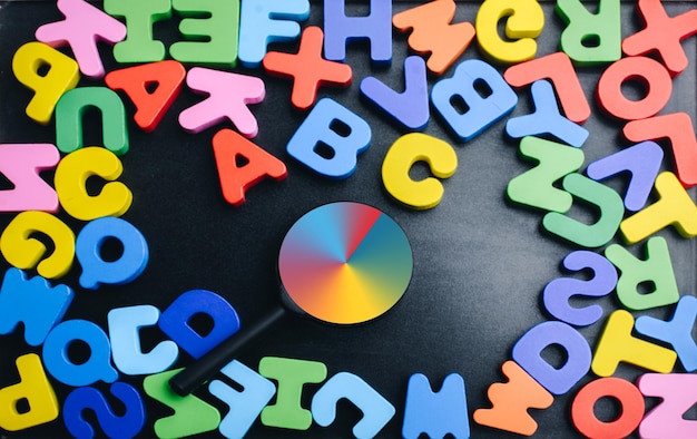 Foto lente d'ingrandimento e lettere colorate dell'alfabeto