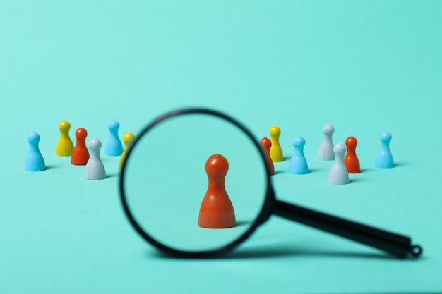 Photo magnifying glass and figurines on blue background