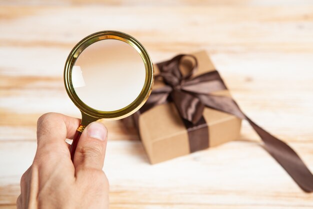 Magnifying glass and a gift on the table