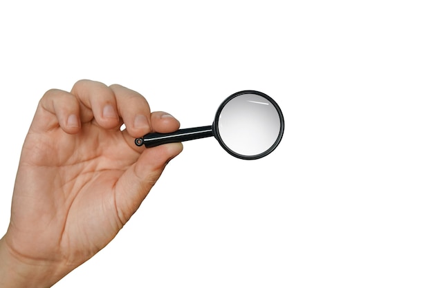 Magnifying glass in a hand isolated on a white background Concept of searching looking through magnifier researching and scanning Isolated male hand holding loupe Using lens to look thoroughly