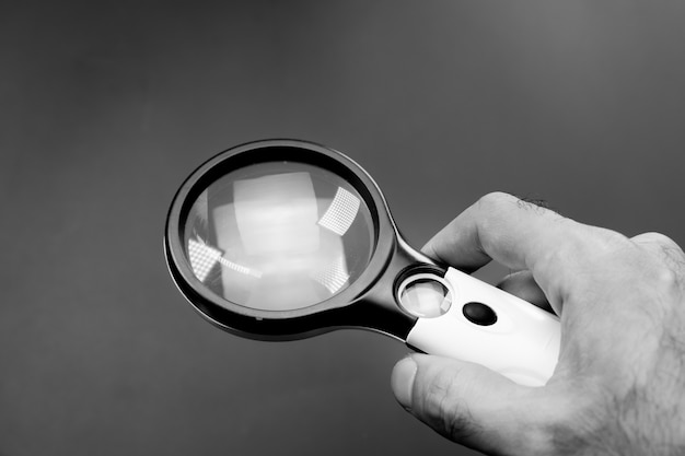 Magnifying glass in the hands of a man