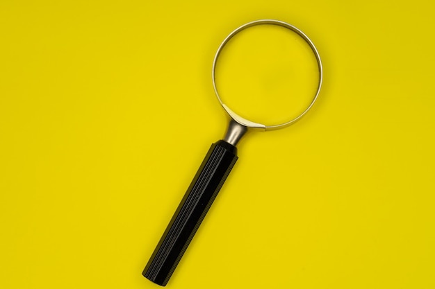 Magnifying glass isolated on yellow background