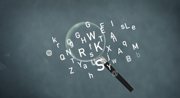 Magnifying glass and latin letters on a gray background