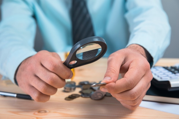 Magnifying glass looking at coins