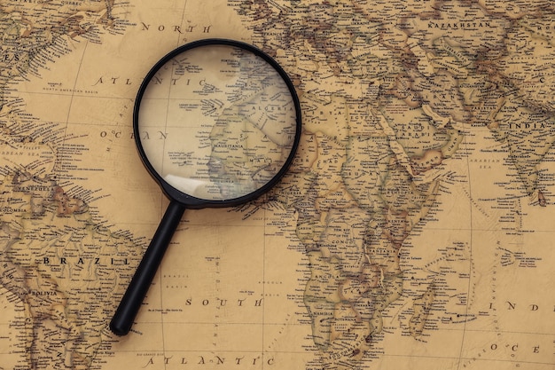 Magnifying glass on old map. Travel, adventure concept