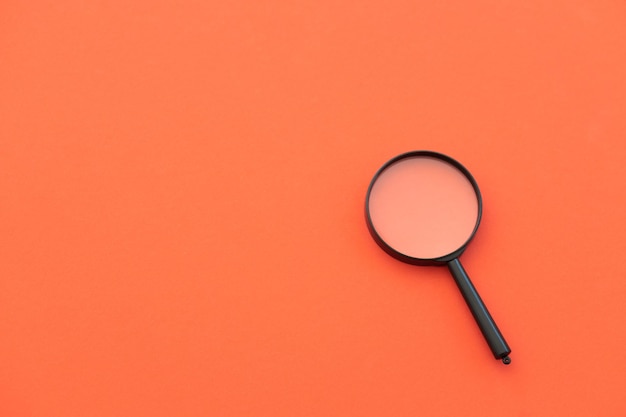 Magnifying glass on red background