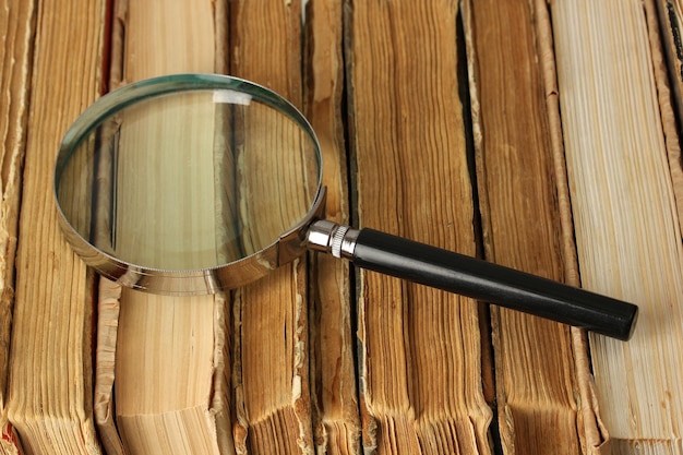 Magnifying glass over the stack of books