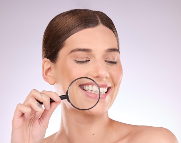 Magnifying glass teeth or woman with dental smile or natural face beauty in oral health hygiene routine Search tooth or happy girl model with lens for wellness clean mouth or treatment in studio