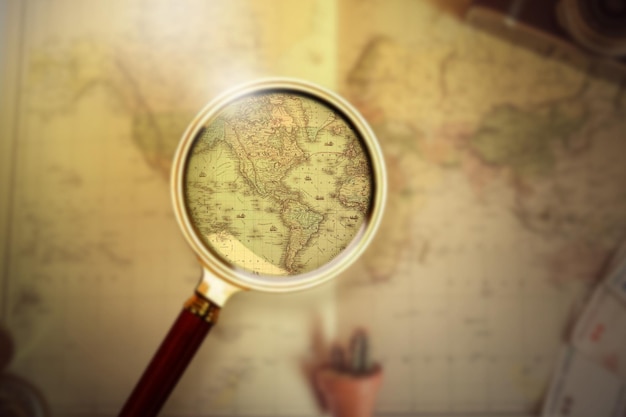 magnifying glass on vintage retro usa map and currency vintage camera on antique america map