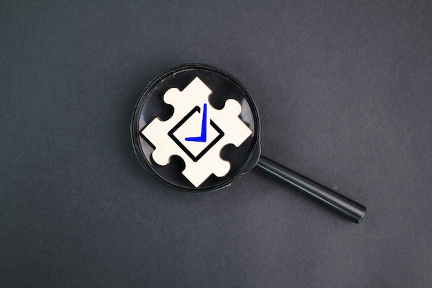 A magnifying glass with a blue arrow on it that says'check'on it