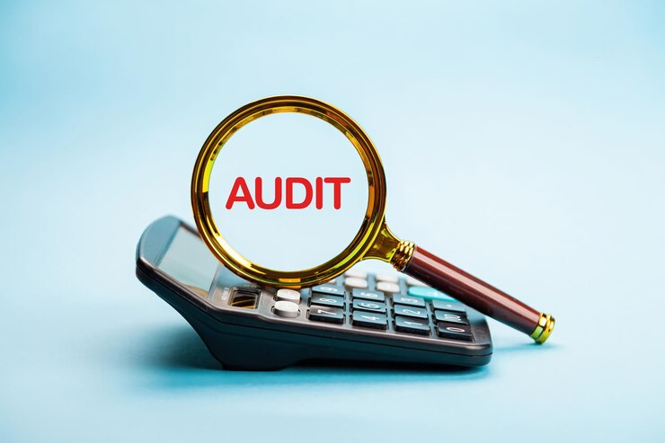 Photo magnifying glass with focus on the word audit audit and check integrity before investment concept us