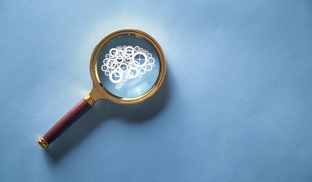 Magnifying glass with a human brain