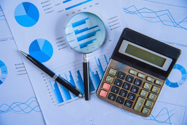 Magnifying glass with paper graph.Analysis concepts