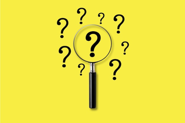 Magnifying glass with question mark symbol. on a yellow background. Searching concept.