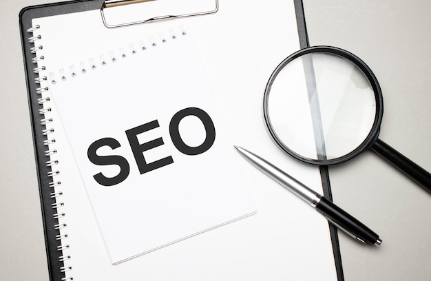 magnifying glass with the word seo on white background