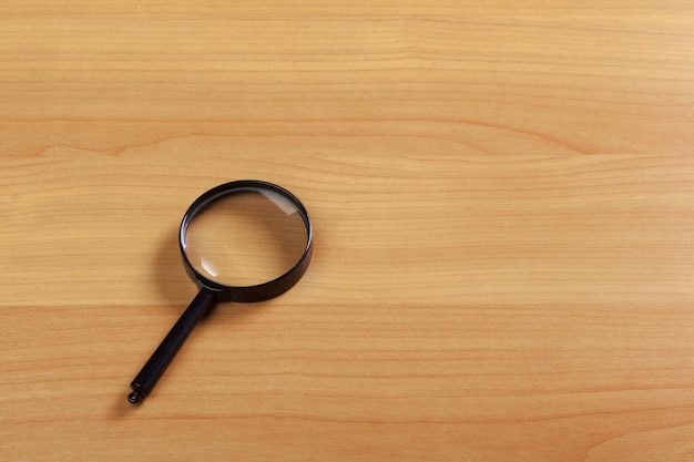 Magnifying glass on the wood