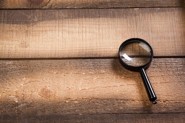 Photo magnifying glass on the wood