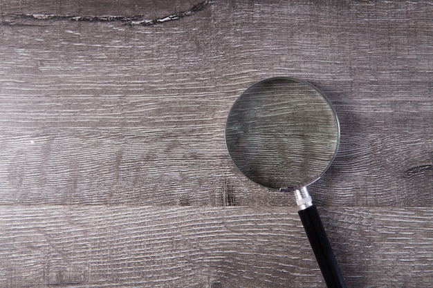 Magnifying glass on a wooden table