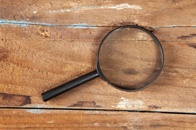 Magnifying glass on a wooden table