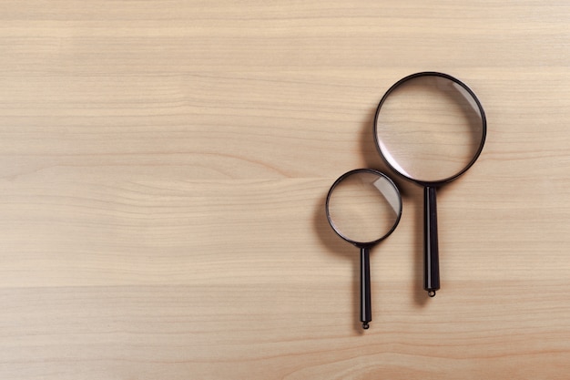 Magnifying glass on the wooden 