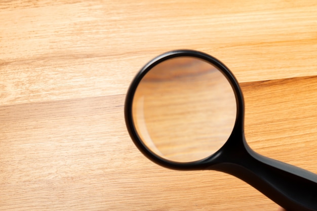 Photo magnifying glass on the wooden