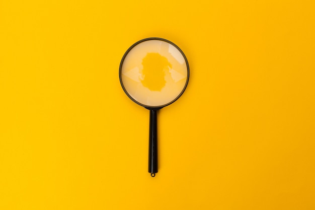 Photo magnifying glass on yellow